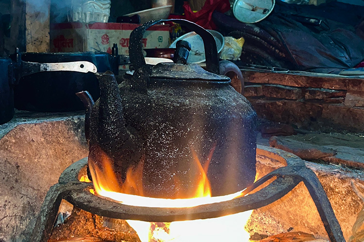 Tibetan brick tea boiling on firewood in a pot. It is a local drink in Tsum valley.
